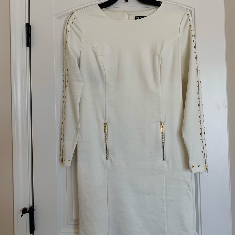Cream colored dress with gold studs on side